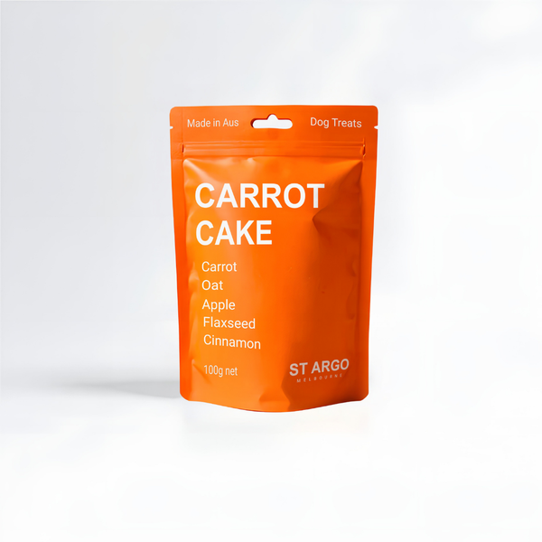 Orange package of St Argo Carrot Cake dog treats on a white background