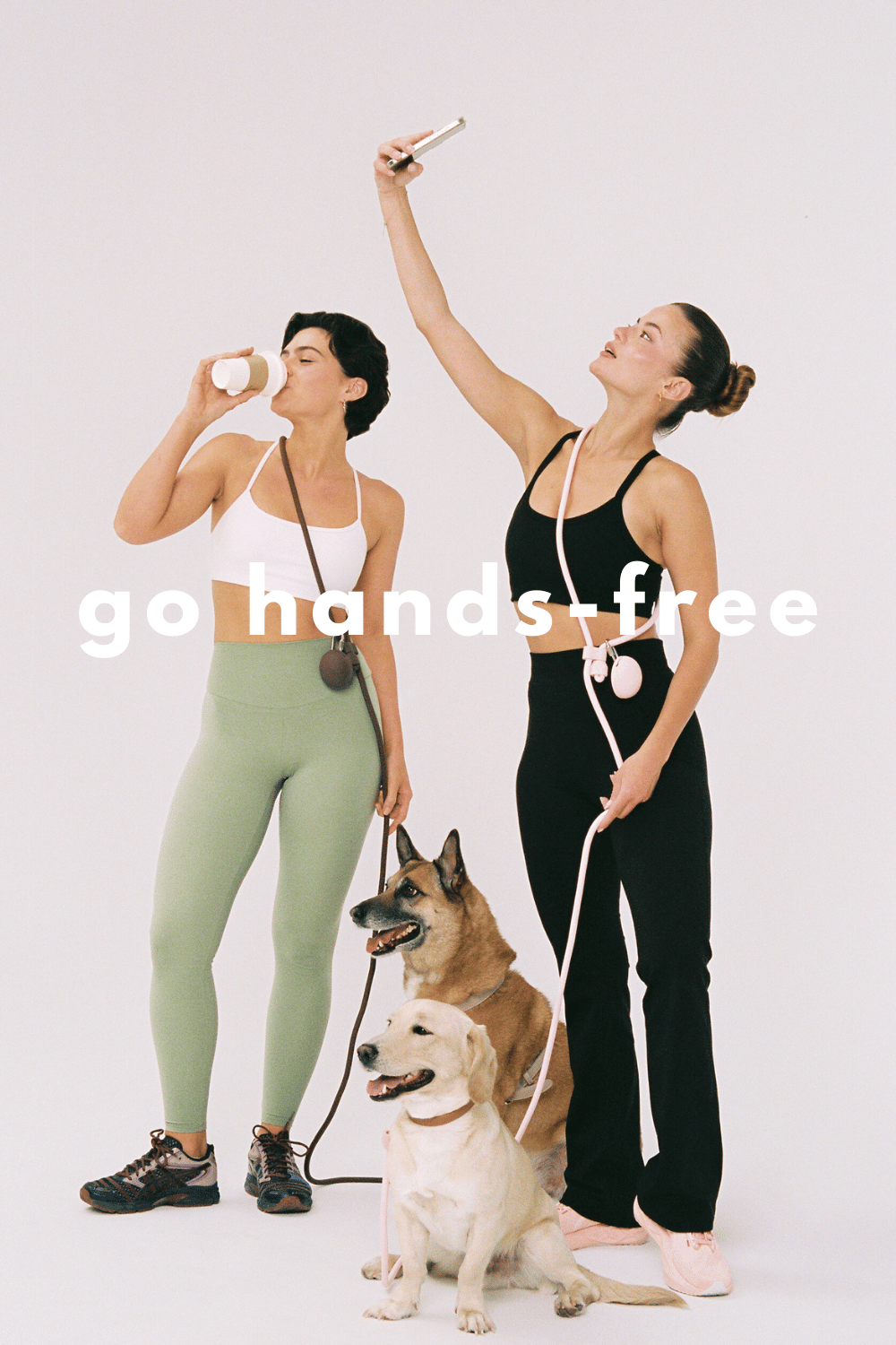 Two women taking a selfie with their dogs, with text 'go hands-free' on a white background.