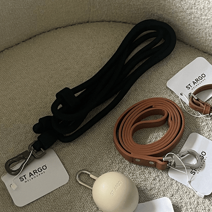 the black hands free leash against boucle lounge