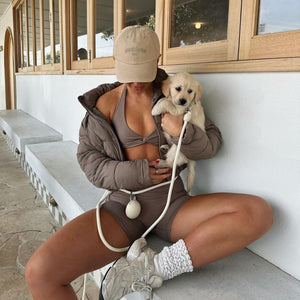 dog mom wears the hands free leash and treat pouch with her golden retriever puppy