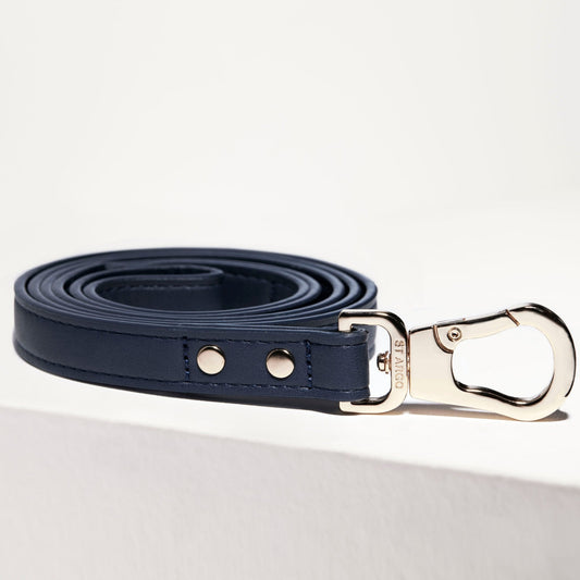 Navy blue dog lead by St Argo with gold hardware