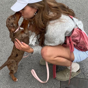 Pale pink vegan leather dog lead with rose gold hardware and happy dog owner